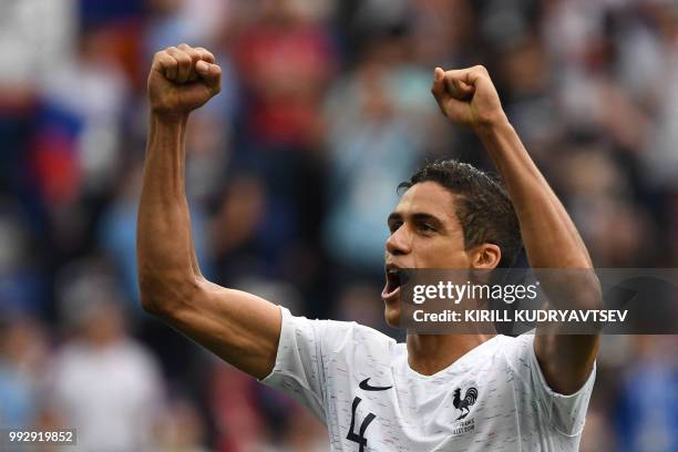 France's defender Raphael Varane celebrates their victory at the end of the Russia 2018 World Cup quarter-final football match between Uruguay and...