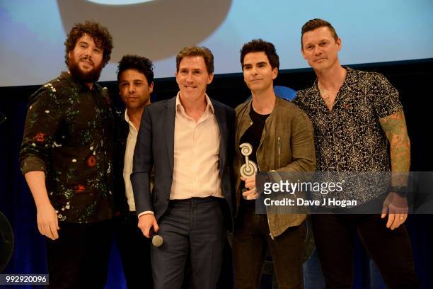 Jamie Morrison, Adam Zindani, presenter Rob Brydon, Kelly Jones and Richard Jones of the Stereophonics, winners of the American Express Icon Award on...