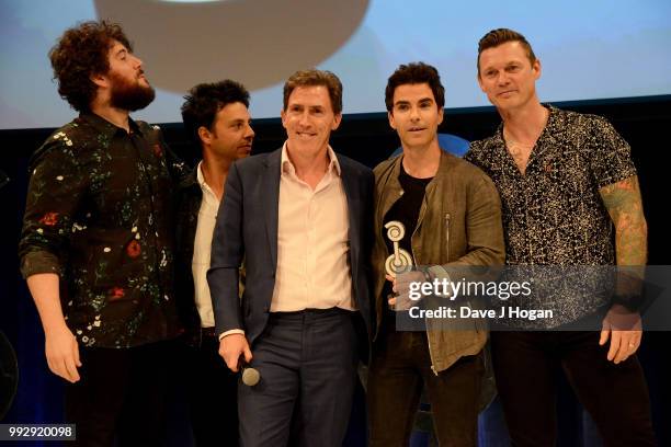 Jamie Morrison, Adam Zindani, presenter Rob Brydon, Kelly Jones and Richard Jones of the Stereophonics, winners of the American Express Icon Award on...