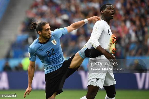 Uruguay's defender Martin Caceres vies with France's midfielder Paul Pogba during the Russia 2018 World Cup quarter-final football match between...