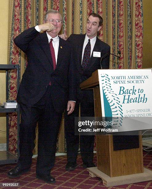 Representative Charlie Norwood, R-Ga, demonstrates exercises to prevent back injury during a lunchen put on by the North American Spine Society while...