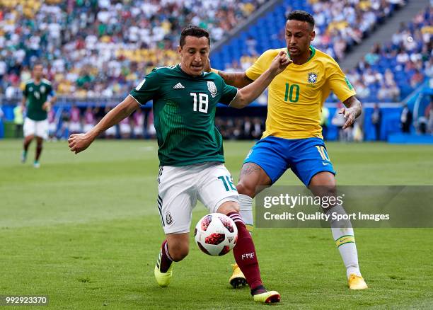 Neymar Jr of Brazil competes for the ball with Andres Guardado of Mexico during the 2018 FIFA World Cup Russia Round of 16 match between Brazil and...