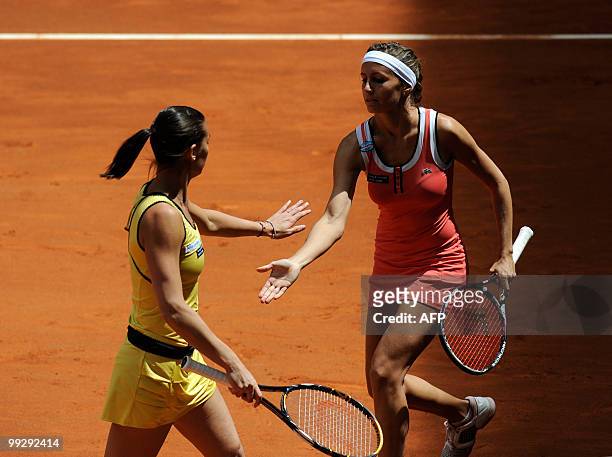 Argentina's Gisela Dulko and Italian Flavia Pennetta celebrate winning a point against Spain's Nuria llagostera and Maria Jose Martine during their...