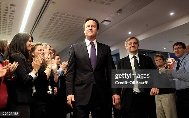 British Prime Minister David Cameron arrives with Chris Huhne , the Secretary of State for Energy and Climate Change, to address the staff in the...