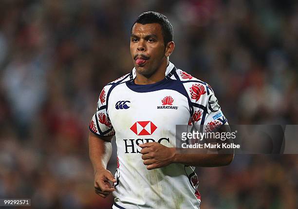 Kurtley Beale of the Waratahs pokes out his tongue as he runs during the round 14 Super 14 match between the Waratahs and the Hurricanes at Sydney...