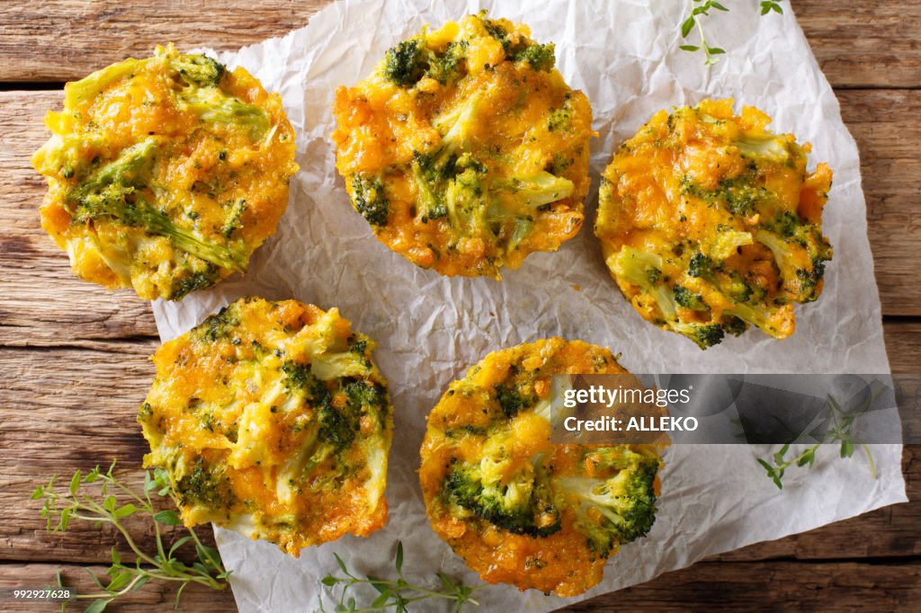 Broccoli bites with cheddar cheese, egg and thyme close-up on the table. Horizontal top view