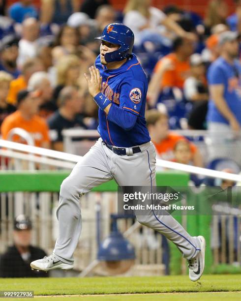 Wilmer Flores of the New York Mets runs home against the Miami Marlins at Marlins Park on June 29, 2018 in Miami, Florida.