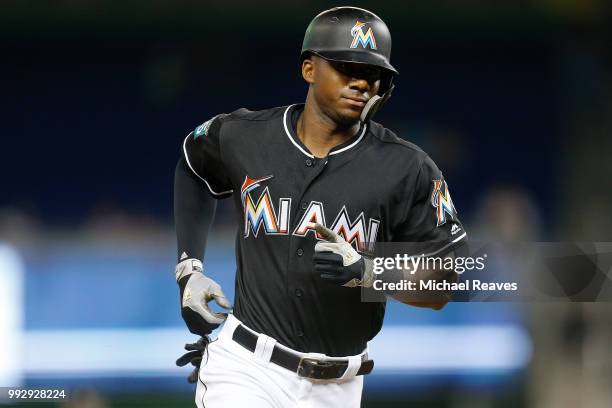 Lewis Brinson of the Miami Marlins rounds the bases after hitting solo home run in the third inning against the New York Mets at Marlins Park on June...