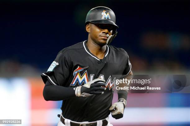 Lewis Brinson of the Miami Marlins rounds the bases after hitting solo home run in the third inning against the New York Mets at Marlins Park on June...