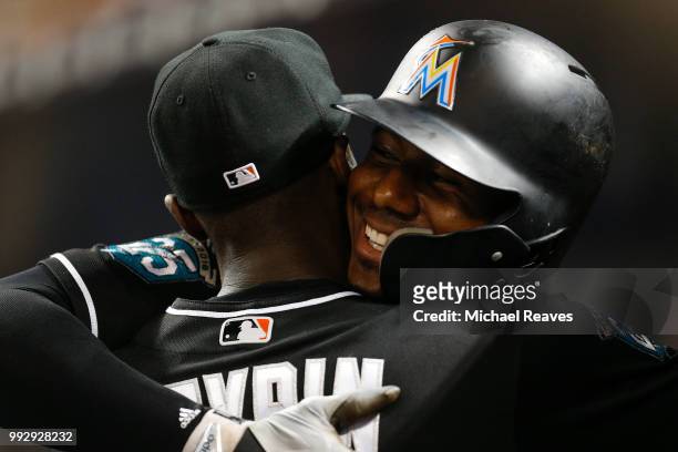 Lewis Brinson of the Miami Marlins celebrates with Cameron Maybin after hitting a solo home run against the New York Mets at Marlins Park on June 29,...