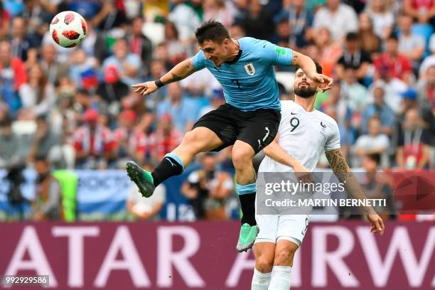 Uruguay's midfielder Cristian Rodriguez and France's forward Olivier Giroud vie for the ball during the Russia 2018 World Cup quarter-final football...