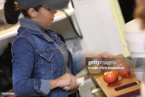 Lufan Valencia chops tomatoes in the kitchen of Bistro Italiano on 320 D St. NE.