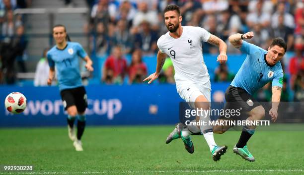 France's forward Olivier Giroud and Uruguay's midfielder Cristian Rodriguez vie during the Russia 2018 World Cup quarter-final football match between...