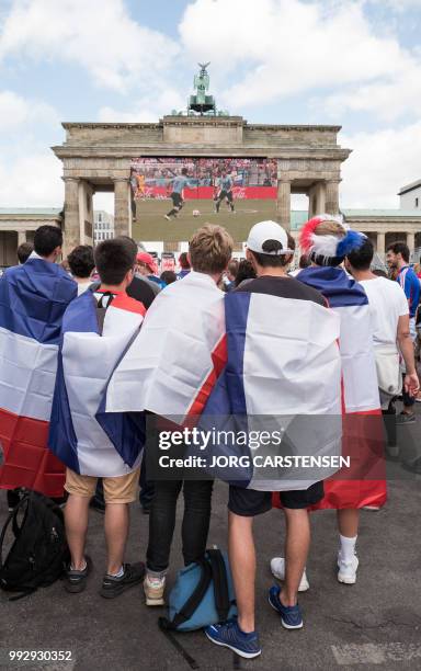 France supporters watch the Russia 2018 World Cup quarter-final football match between Uruguay and France on a giant screen in front of the...