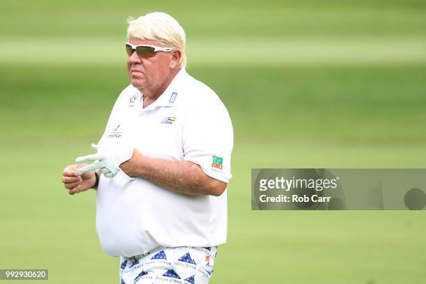 John Daly takes off his glove on the 11th hole during round two of A Military Tribute At The Greenbrier held at the Old White TPC course on July 6,...