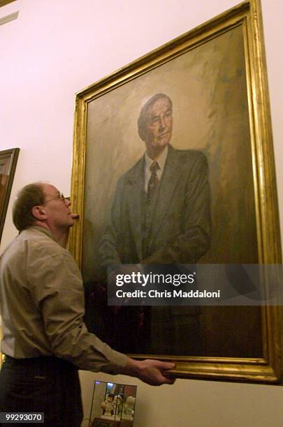Alan Burns, Political Collections Archivist at Clemson University, removes a portrait of retiring Sen. Strom Thurmond from the Senator's office.