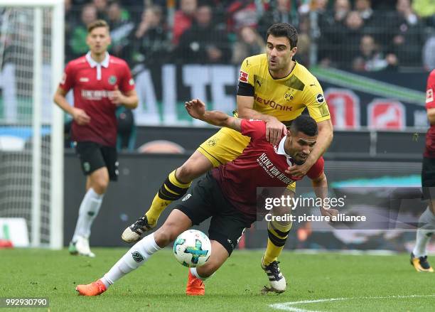 Dortmund's Sokratis and Hanover's Jonathas Cristian vie for the ball during the Bundesliga soccer match between Hanover 96 and Borussia Dortmund in...