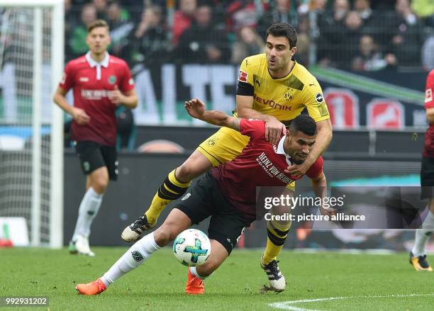 Dortmund's Sokratis and Hanover's Jonathas Cristian vie for the ball during the German Bundesliga football match between Hanover 96 and Borussia...