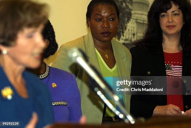 Mary Mogga , a naturalized citizen from Sudan, and Daisy Nardi , an immigrant from Brazil who is waiting to take her oath of citizenship, watch Rep....