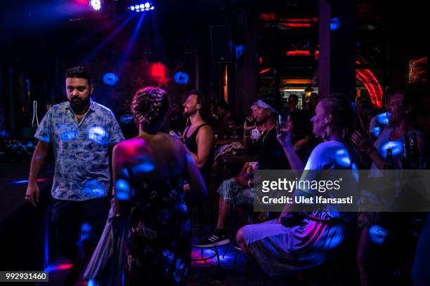 Tourists watch drag queens perform a cabaret show in Mixwell bar on July 4, 2018 in Seminyak, Bali, Indonesia. For the past 12 years Mixwell bar has...