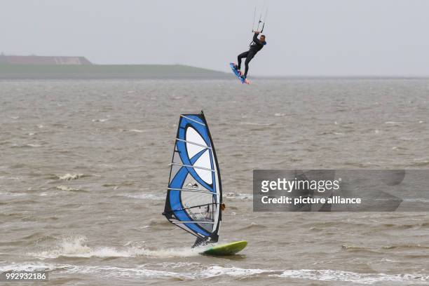 Dpatop - One wind and one kite surfer on the North Sea off the beach at Norddeich, Germany, 28 October 2017. Photo: Mohssen Assanimoghaddam/dpa