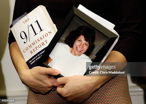 Carie LeMack, whose mother died in 9/11,held a copy of the 9/11 commssion report and a picture of her mother today at press conference urging...