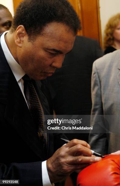Muhammad Ali, former heavy weight champion, signs a glove after testifying at the House Professional Boxing Reforms Commerce, Trade, and Consumer...