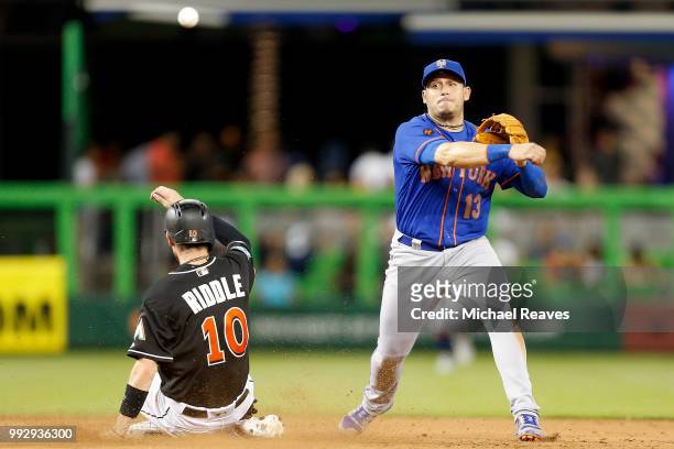 Asdrubal Cabrera of the New York Mets turns a double play against the Miami Marlins at Marlins Park on June 29, 2018 in Miami, Florida.