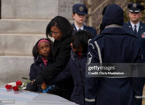 Sandra Anderson, widow of Lt. Col. Michael Anderson, and their daughters, place roses on the astronaut's coffin. Anderson was one of the seven...