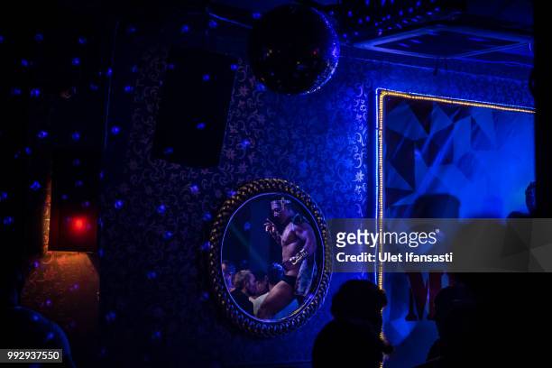 An Indonesian male Go-Go dancer is reflection on a mirror as performs in Mixwell bar on July 5, 2018 in Seminyak, Bali, Indonesia. For the past 12...