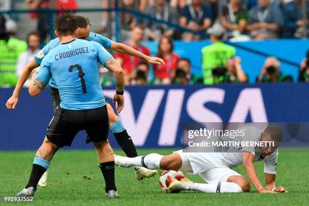 Uruguay's midfielder Cristian Rodriguez, Uruguay's defender Diego Laxalt and France's forward Kylian Mbappe in action during the Russia 2018 World...