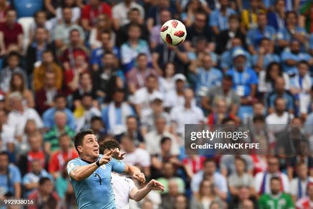 Uruguay's midfielder Cristian Rodriguez heads the ball with France's defender Benjamin Pavard during the Russia 2018 World Cup quarter-final football...