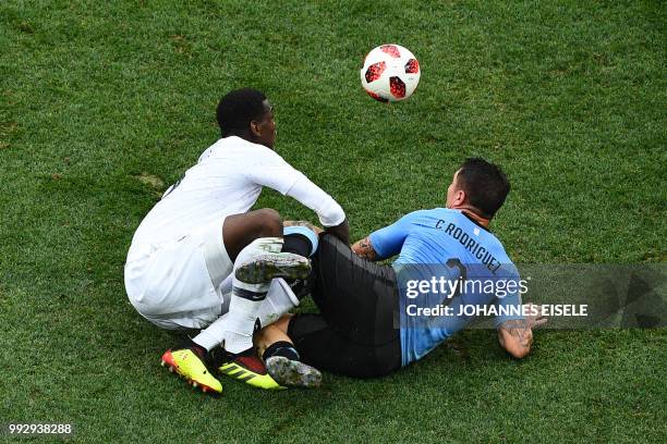 France's midfielder Paul Pogba vies for the ball with Uruguay's midfielder Cristian Rodriguez during the Russia 2018 World Cup quarter-final football...