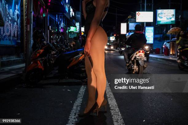 Indonesian drag queen Sachiko Gawinna stands outside a bar trying to get customers on July 5, 2018 in Seminyak, Bali, Indonesia. For the past 12...