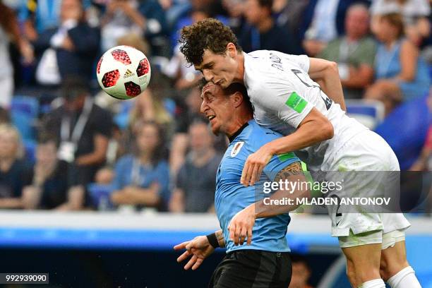 Uruguay's midfielder Cristian Rodriguez heads the ball with France's defender Benjamin Pavard during the Russia 2018 World Cup quarter-final football...