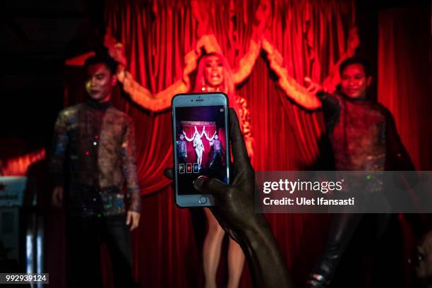 Man take a pictures use his smartphone as drag queens performing in Mixwell bar on July 5, 2018 in Seminyak, Bali, Indonesia. For the past 12 years...