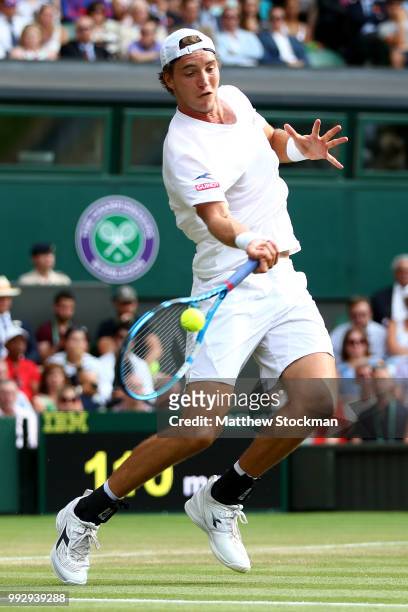 Jan-Lennard Struff of Germany returns against Roger Federer of Switzerland during their Men's Singles third round match on day five of the Wimbledon...