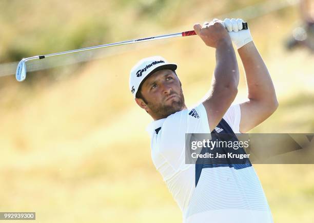 Jon Rahm of Spain plays his second shot into the 18th green during the second round of the Dubai Duty Free Irish Open at Ballyliffin Golf Club on...