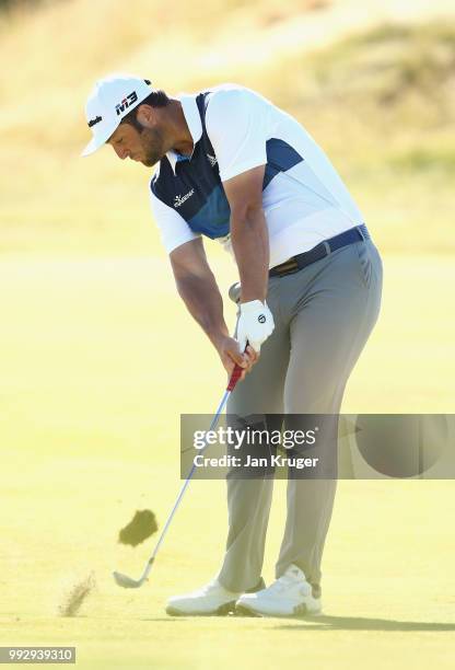 Jon Rahm of Spain plays his second shot into the 18th green during the second round of the Dubai Duty Free Irish Open at Ballyliffin Golf Club on...