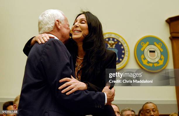 Retired Navy Medical Corps Capt. Bob Meader, founder of Operation-Helmet, greets singer Cher, before a House Armed Services Tactical Air and Land...