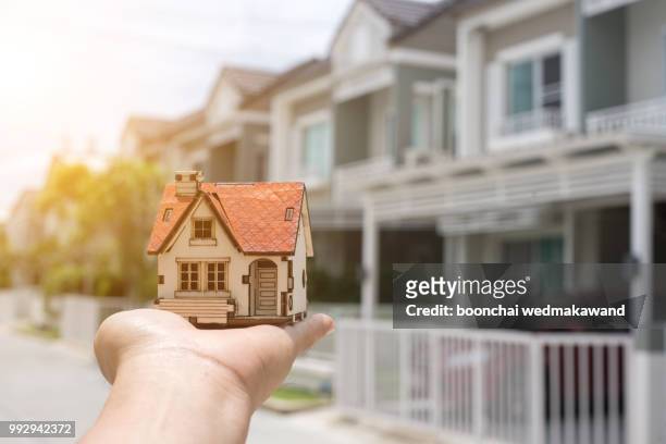 businessman holding home model. loan concept - seguro del hogar fotografías e imágenes de stock