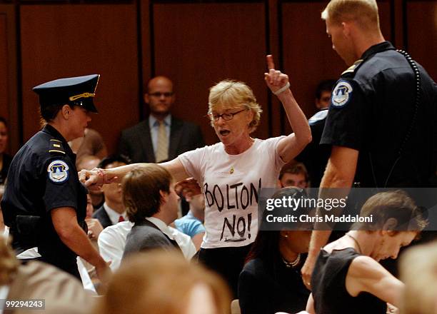 Protester interrupts John Bolton as he testifies at a Senate Foreign Relations committee hearing on his nomination to be ambassador and U.S....