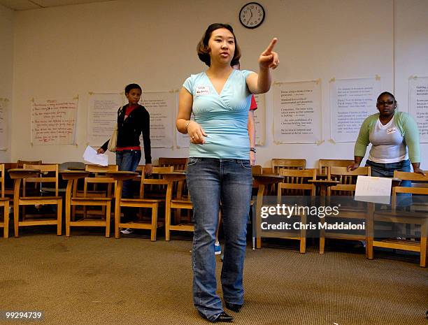 Bemidji State University student Lisa Radintz helps move chairs for a Dr George L. Peabody's seminar, "Power and Values in Organizations," a popular...