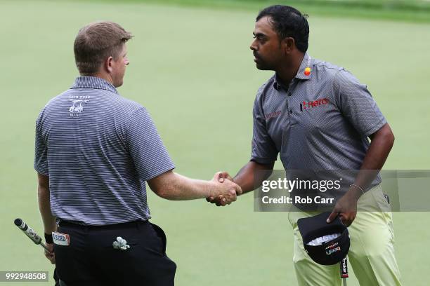 Martin Piller of the US and Anirban Lahiri of India shake hands as they finish on the ninth hole during round two of A Military Tribute At The...