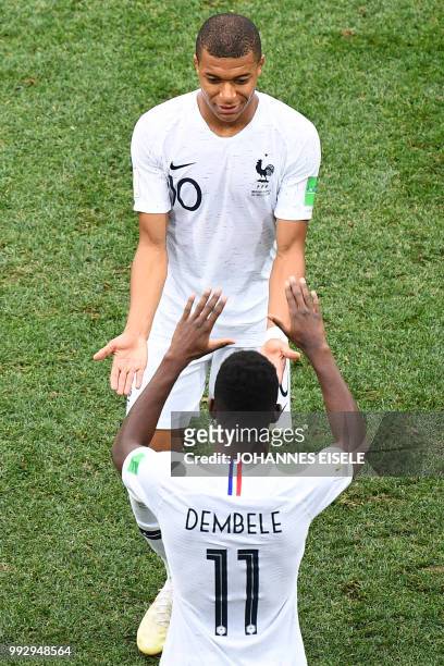 France's forward Kylian Mbappe is replaced by France's forward Ousmane Dembele during the Russia 2018 World Cup quarter-final football match between...
