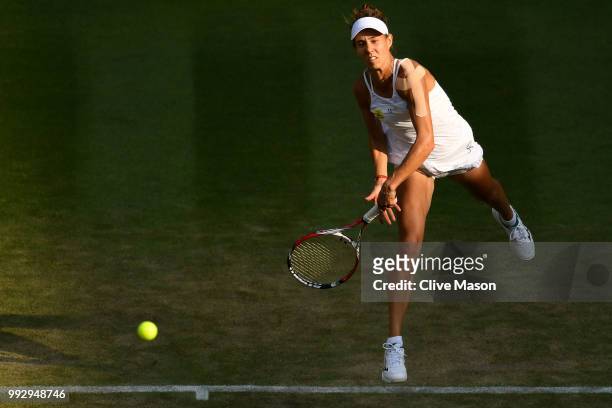 Mihaela Buzarnescu of Romania returns a shot against Karolina Pliskova of Czech Republic during their Ladies' Singles third round match on day five...