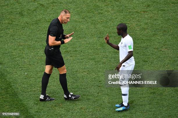 Argentine referee Nestor Pitana speaks with France's midfielder N'Golo Kante during the Russia 2018 World Cup quarter-final football match between...