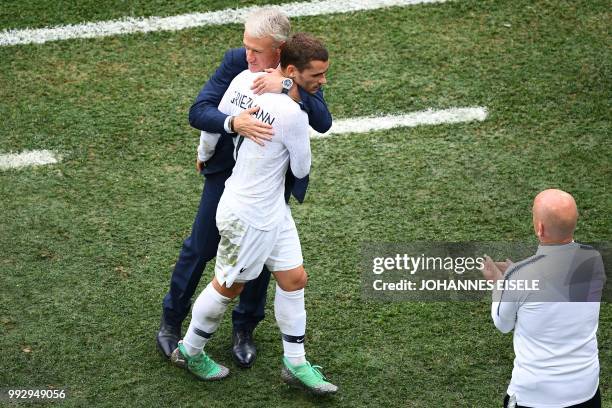 France's coach Didier Deschamps greets France's forward Antoine Griezmann during the Russia 2018 World Cup quarter-final football match between...