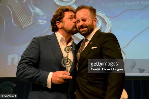 Michael Ball and Alfie Boe, winners of the PPL Classical Award on stage during the Nordoff Robbins' O2 Silver Clef Awards ceremony at Grosvenor...