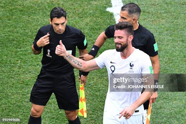 France's forward Olivier Giroud gestures to the referee during the Russia 2018 World Cup quarter-final football match between Uruguay and France at...